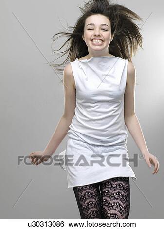Smiling girl jumping for joy View Large Photo Image Stock Photograph - Smiling girl jumping for joy. Fotosearch