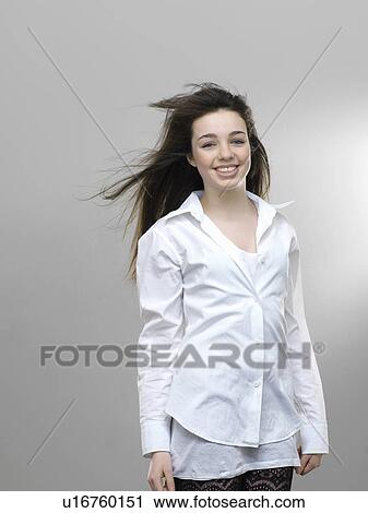Smiling girl’s hair blowing in wind View Large Photo Image Stock Image - Smiling girl’s hair blowing in wind. Fotosearch