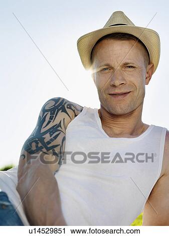 Smiling man wearing sunhat outdoors View Large Photo Image Stock Image - Smiling man wearing sunhat outdoors. Fotosearch