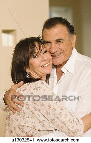 Smiling older couple hugging View Large Photo Image Stock Image - Smiling older couple hugging. Fotosearch