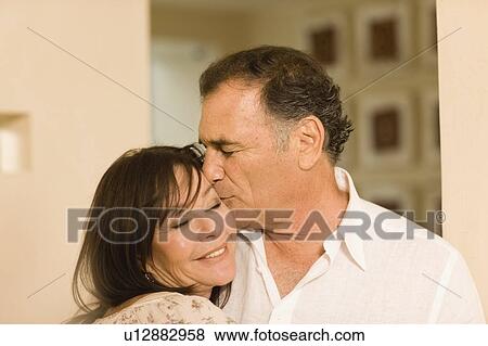 Smiling older couple kissing View Large Photo Image Stock Photo - Smiling older couple kissing. Fotosearch