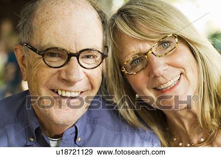 Smiling older couple wearing eyeglasses View Large Photo Image Stock Photo - Smiling older couple wearing eyeglasses. Fotosearch