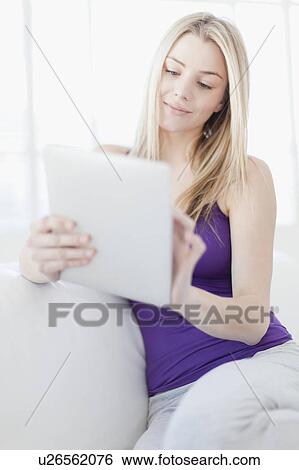 Smiling teenage girl using tablet View Large Photo Image Stock Photograph - Smiling teenage girl using tablet. Fotosearch