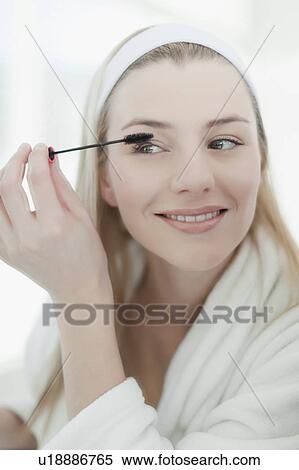 Smiling woman applying makeup View Large Photo Image Stock Photography - Smiling woman applying makeup. Fotosearch