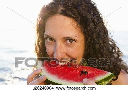 Smiling woman eating watermelon View Large Photo Image Picture - Smiling woman eating watermelon. Fotosearch