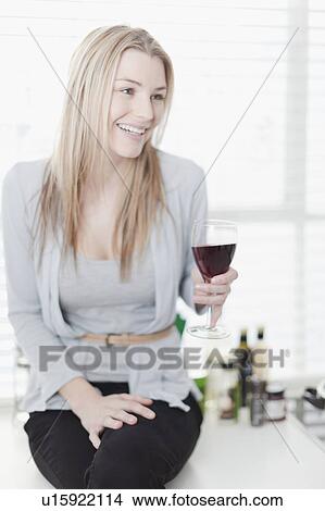 Smiling woman having glass of wine View Large Photo Image Picture - Smiling woman having glass of wine. Fotosearch