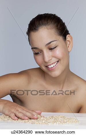 Smiling woman playing with grains View Large Photo Image Stock Image - Smiling woman playing with grains. Fotosearch
