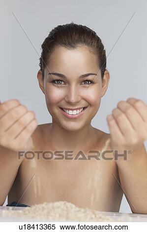 Smiling woman playing with grains View Large Photo Image Stock Photography - Smiling woman playing with grains. Fotosearch