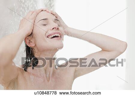 Stock Photo - Smiling woman taking shower. Fotosearch