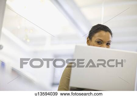 Smiling woman using laptop View Large Photo Image Stock Photo - Smiling woman using laptop. Fotosearch