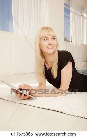 Smiling woman using tablet computer View Large Photo Image Stock Photography - Smiling woman using tablet computer. Fotosearch