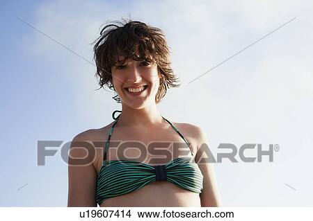 Picture - Smiling woman wearing bikini outdoors. Fotosearch