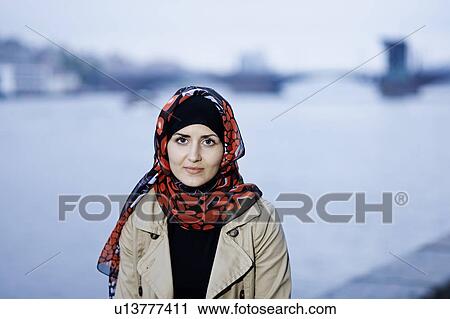Stock Image - Smiling woman wearing headscarf. Fotosearch
