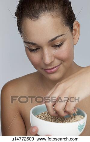 Smiling woman with bowl of grains View Large Photo Image Stock Photo - Smiling woman with bowl of grains. Fotosearch