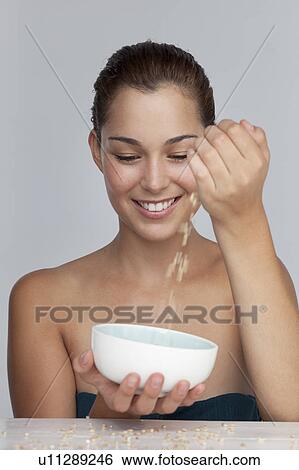 Stock Photograph - Smiling woman with bowl of grains. Fotosearch