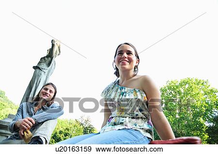 Smiling women sitting in park View Large Photo Image Stock Photo - Smiling women sitting in park. Fotosearch