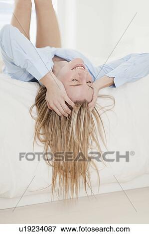 Stock Photo - Stressed woman laying on bed. Fotosearch