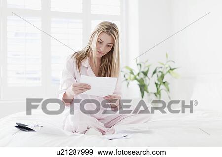 Stressed woman working on bed View Large Photo Image Stock Photo - Stressed woman working on bed. Fotosearch