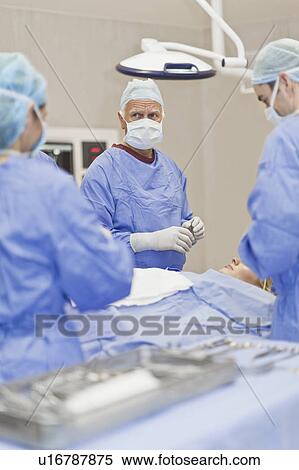 Surgeons at work in operating room View Large Photo Image Stock Photography - Surgeons at work in operating room. Fotosearch