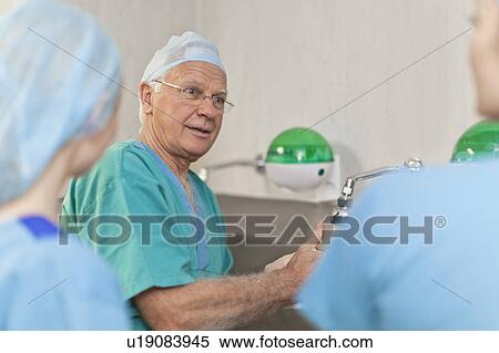 Stock Photography - Surgeons washing hands before operation. Fotosearch