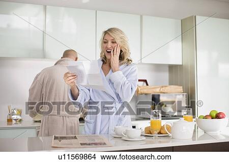 Surprised woman reading mail View Large Photo Image Picture - Surprised woman reading mail. Fotosearch