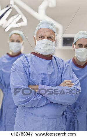 Stock Photo - Team of doctors in operating room. Fotosearch
