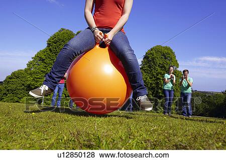 Stock Photo - Teams racing on exercises balls. Fotosearch