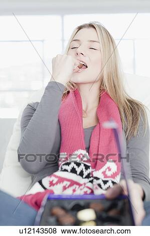 Teenage girl eating box of chocolates View Large Photo Image Stock Photo - Teenage girl eating box of chocolates. Fotosearch
