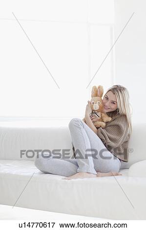 Stock Photo - Teenage girl hugging stuffed toy. Fotosearch