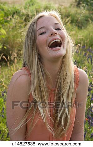 Teenage girl laughing outdoors View Large Photo Image Stock Photo - Teenage girl laughing outdoors. Fotosearch