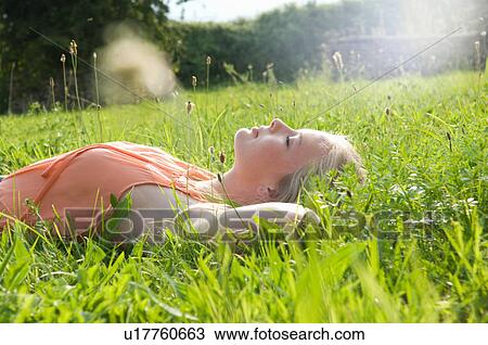 Teenage girl laying in tall grass View Large Photo Image Stock Image - Teenage girl laying in tall grass. Fotosearch
