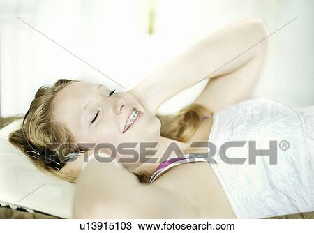 Teenage girl listening to headphones View Large Photo Image Stock Image - Teenage girl listening to headphones. Fotosearch