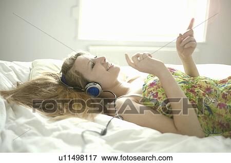Teenage girl listening to headphones View Large Photo Image Stock Photo - Teenage girl listening to headphones. Fotosearch