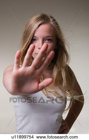 Picture - Teenage girl making stop gesture. Fotosearch