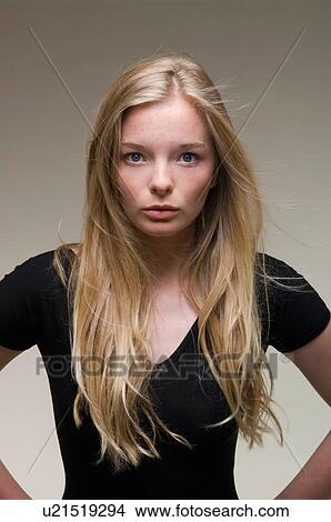 Teenage girl standing with hands on hips View Large Photo Image Picture - Teenage girl standing with hands on hips. Fotosearch