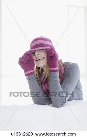 Stock Image - Teenage girl wearing hat and gloves. Fotosearch