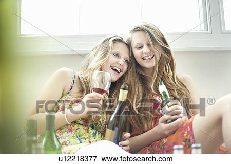 Teenage girls drinking alcohol together View Large Photo Image Stock Photo - Teenage girls drinking alcohol together. Fotosearch