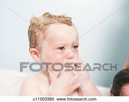 Toddler crying in bubble bath View Large Photo Image Stock Photography - Toddler crying in bubble bath. Fotosearch