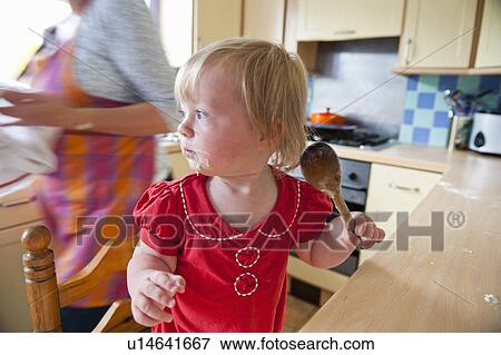 Stock Photo - Toddler girl baking with mother. Fotosearch