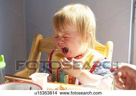 Toddler girl crying at table View Large Photo Image Picture - Toddler girl crying at table. Fotosearch
