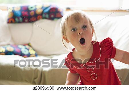 Toddler girl gasping in living room View Large Photo Image Stock Image - Toddler girl gasping in living room. Fotosearch