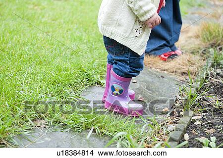 Toddler girl wearing pink rainboots View Large Photo Image Picture - Toddler girl wearing pink rainboots. Fotosearch