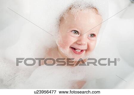 Toddler playing in bubble bath View Large Photo Image Stock Photo - Toddler playing in bubble bath. Fotosearch
