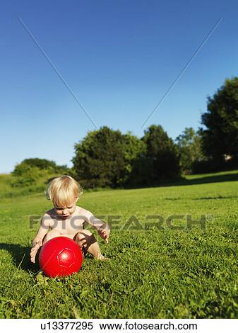 Toddler playing with red ball outdoors View Large Photo Image Stock Photography - Toddler playing with red ball outdoors. Fotosearch