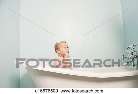 Stock Image - Toddler sitting in bubble bath. Fotosearch
