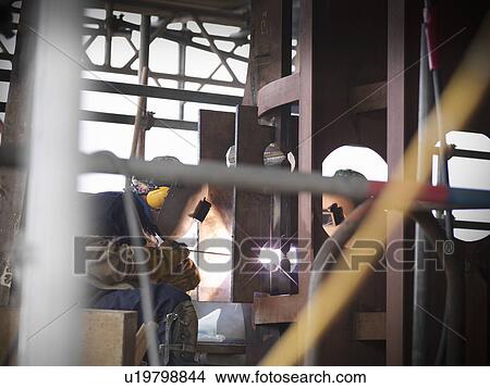 Picture - Welders at work building ship. Fotosearch
