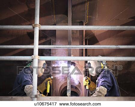 Welders at work building ship View Large Photo Image Stock Photo - Welders at work building ship. Fotosearch
