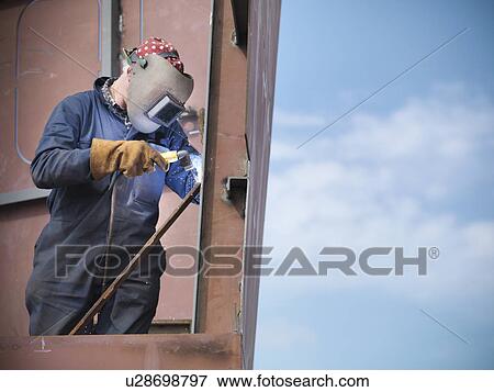 Stock Photo - Welders at work building ship. Fotosearch