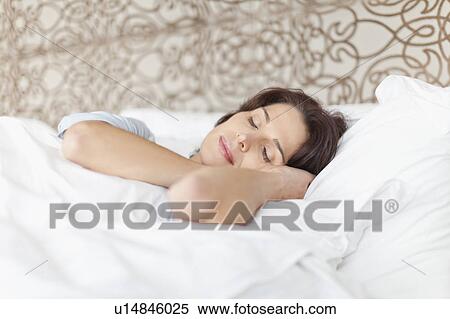 Stock Photography - Woman asleep in bed. Fotosearch
