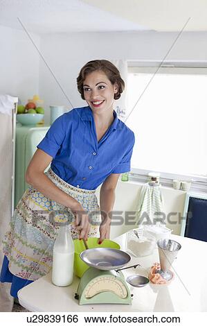 Stock Photograph - Woman baking in kitchen. Fotosearch